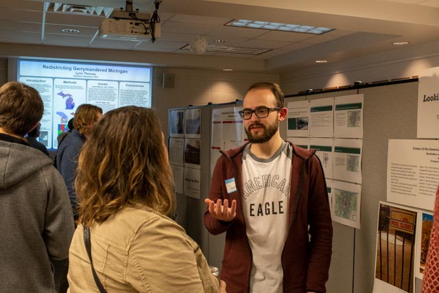 Students sharing their research findings on posters